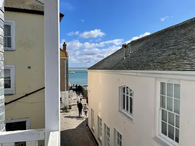 a view of the ocean from between two buildings at 1 Sunnyside - views over the St Ives Harbour in St Ives
