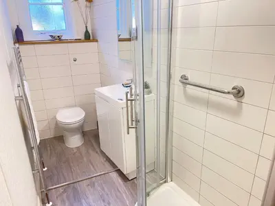 a bathroom with a shower and a toilet at 1 Sunnyside - views over the St Ives Harbour in St Ives