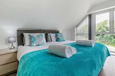 a bedroom with a large bed with a large window at 4 Bed in Retorrick Mill oc-t28899 in Saint Mawgan
