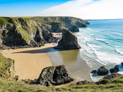 a view of a beach with rocks and the ocean at 4 Bed in Retorrick Mill oc-t28899 in Saint Mawgan