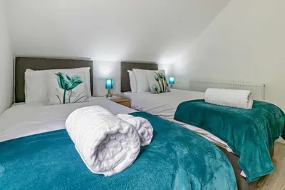 two beds with blankets and pillows in a bedroom at 4 Bed in Retorrick Mill oc-t28899 in Saint Mawgan