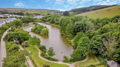an aerial view of a river with trees at 4 Bed in Retorrick Mill oc-w28897 in Saint Mawgan