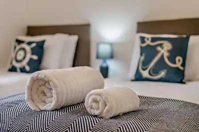 a pair of towels on a bed in a bedroom at 4 Bed in Retorrick Mill oc-w28897 in Saint Mawgan