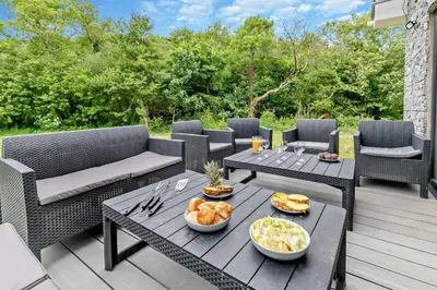 a patio with a table with bowls of food on it at 4 Bed in Retorrick Mill oc-w28897 in Saint Mawgan