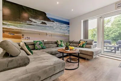 a living room with a couch and a table at 4 Bed in Retorrick Mill oc-p28898 in Saint Mawgan