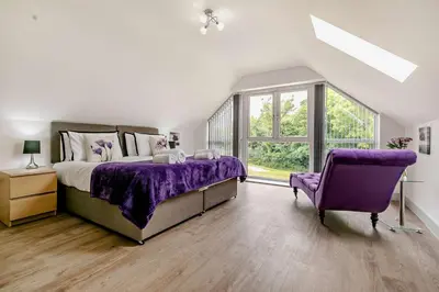 a bedroom with a purple bed and a purple chair at 4 Bed in Retorrick Mill oc-p28898 in Saint Mawgan