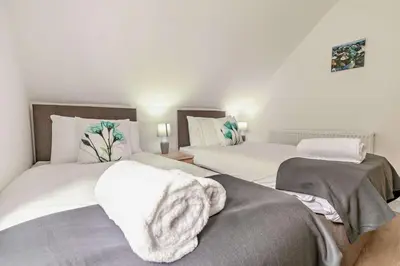 a bedroom with two beds with white sheets at 4 Bed in Retorrick Mill oc-p28898 in Saint Mawgan