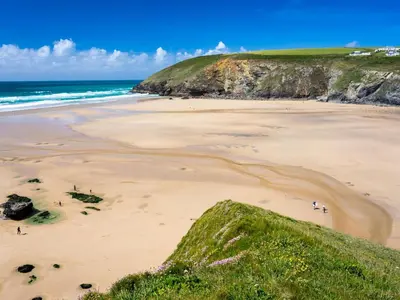 a beach with people walking on the sand at 4 Bed in Retorrick Mill oc-p28898 in Saint Mawgan