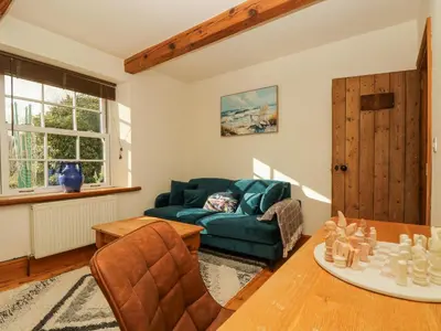 a living room with a couch and a table at Lower Gadles in Penryn