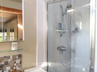 a shower in a bathroom with a glass door at Lower Gadles in Penryn