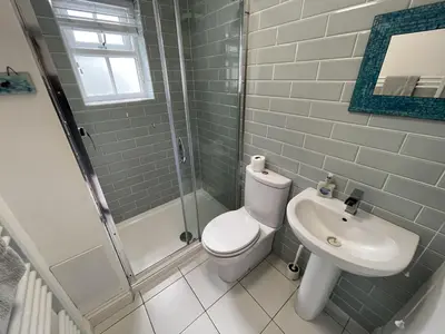 a bathroom with a toilet and a sink at 2 Meadow Villas in St Ives