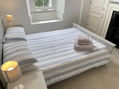 a bed with two towels on it in a room at 2 Meadow Villas in St Ives