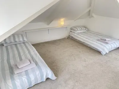 a room with two beds in a attic at 2 Meadow Villas in St Ives