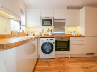 a kitchen with a washing machine and a dishwasher at The Beach Hut in Newquay