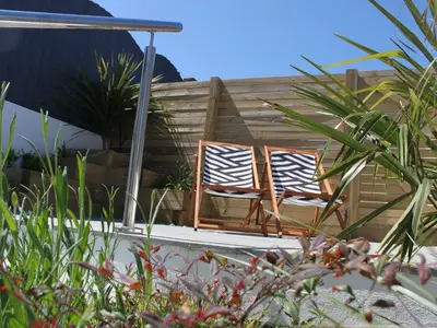 two chairs sitting next to each other in a garden at The Beach Hut in Newquay