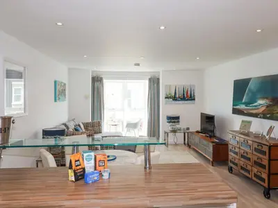 a living room with a glass table and a couch at The Trick in St Ives
