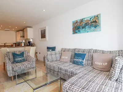 a living room with a couch and two chairs at The Trick in St Ives