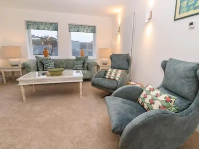 a living room with couches and a coffee table at Fal View in Falmouth