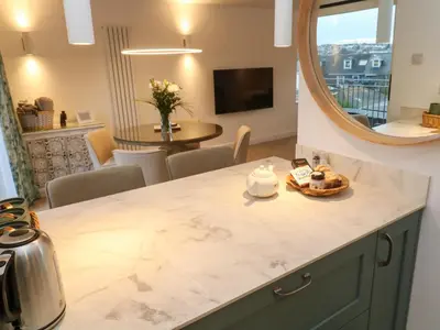 a kitchen with a counter top and a mirror at Fal View in Falmouth