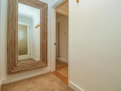 an empty hallway with a large mirror on the wall at Fal View in Falmouth