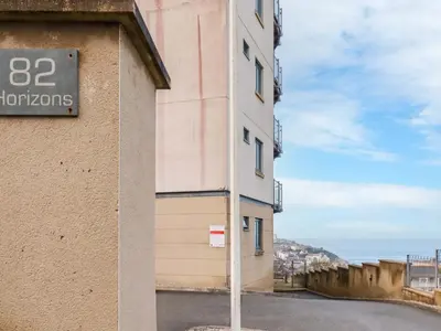 a building with a sign on the side of it at Apartment 3 in Newquay