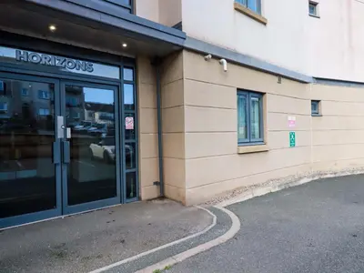 a store front with glass doors on a building at Apartment 3 in Newquay