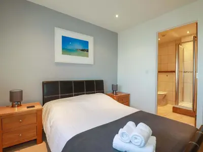 a bedroom with a bed with towels on it at Apartment 3 in Newquay