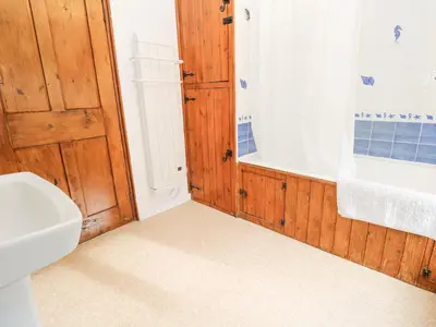 a bathroom with a toilet and a sink and a shower at Penhaven in Helston