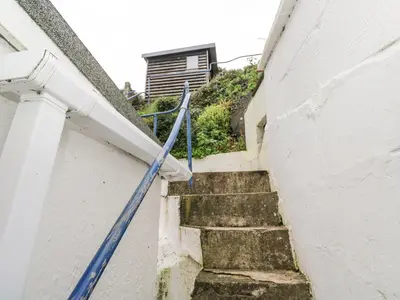 a staircase with a blue rope leading up to a building at Penhaven in Helston