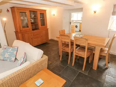 a living room with a table and a couch at Penhaven in Helston