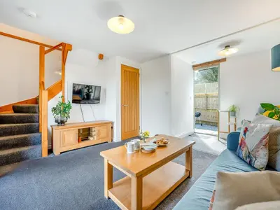 a living room with a couch and a table at Roosters Rest - Uk48255 in Downderry