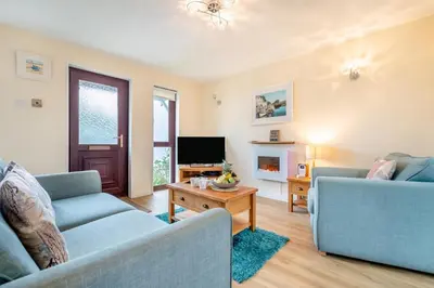 a living room with two blue couches and a tv at 2 Bed in Padstow oc-t30052 in Padstow