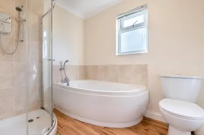 a bathroom with a white tub and a toilet at 3 Bed in St. Merryn oc-r30137 in St Merryn