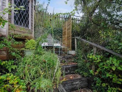 a garden with a bench and a wooden fence at 15 The Moors in Lostwithiel