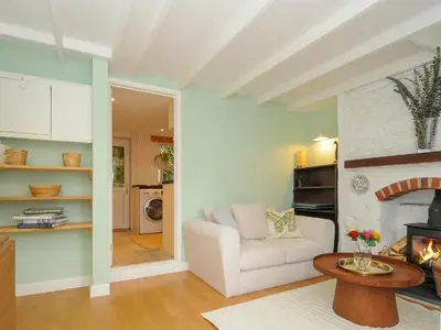 a living room with a couch and a fireplace at 15 The Moors in Lostwithiel