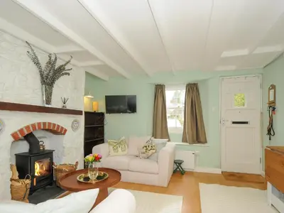 a living room with a couch and a fireplace at 15 The Moors in Lostwithiel