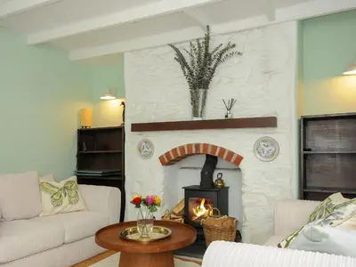 a living room with a fireplace and a couch at 15 The Moors in Lostwithiel