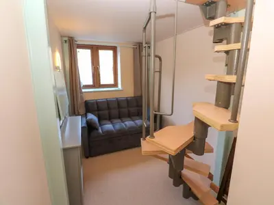a living room with a couch and a table at Harvey's House in Helston