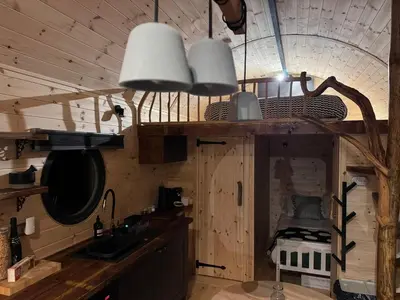 a kitchen with a sink and two lights on the ceiling at The Palm at OLJU Lodges in Ponsanooth