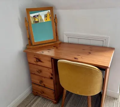 a wooden desk with a mirror and a chair at Seaview Surf Studios in Newquay