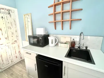 a kitchen with a sink and a microwave at Seaview Surf Studios in Newquay