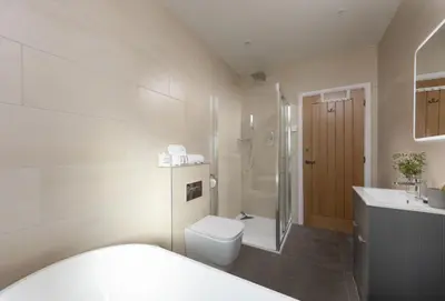a bathroom with a toilet and a sink and a shower at Whitewood in Camborne