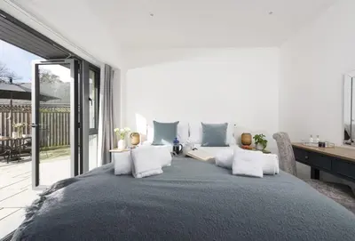 a bedroom with a large bed with white pillows at Whitewood in Camborne