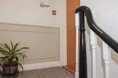 a stairway with a plant next to a door at Kerensa in St Austell