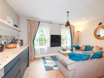a living room with a couch and a table at Kerensa in St Austell
