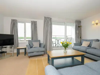 a living room with a couch and chairs and a tv at Slipway 14 in Wadebridge