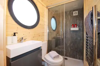 a bathroom with a toilet and a sink and a shower at The Palm in Truro