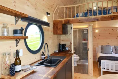 a kitchen in a tiny house with a sink at The Palm in Truro
