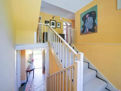 a staircase in a home with yellow walls at Tower Hill in Bodmin