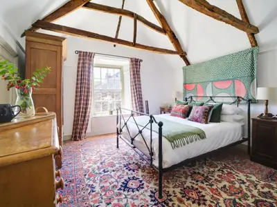 a bedroom with a bed and a window at Tower Hill in Bodmin